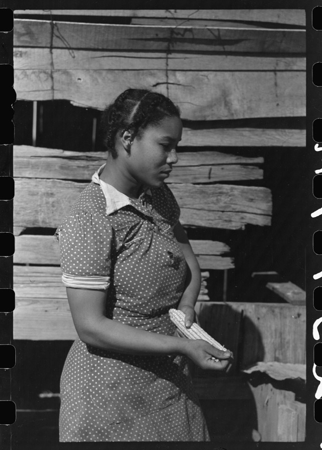 Oldest daughter of Pomp Hall, tenant farmer, with an ear of corn which she is shelling to feed her chickens, Creek County, Oklahoma. See general caption number 23
