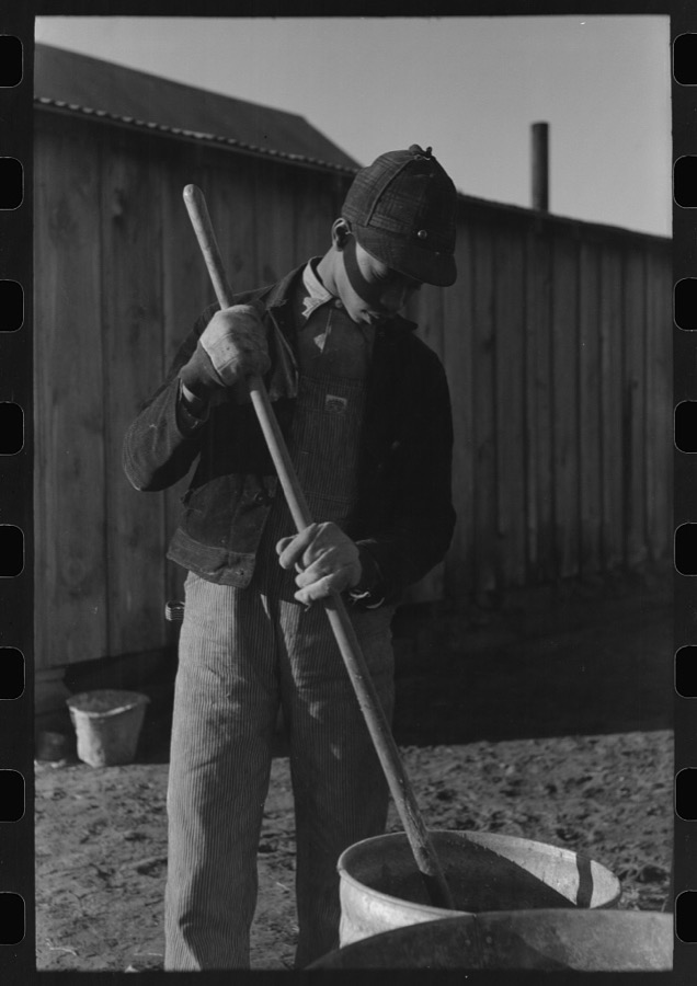 Son of Pomp Hall, Negro tenant farmer, carrying can full of mash to hogpen, Creek County, Oklahoma. See general caption, number 23