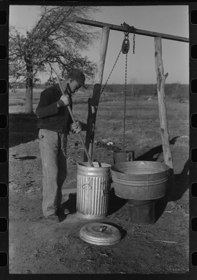 Son of Pomp Hall, Negro tenant farmer, carrying can full of mash to hogpen, Creek County, Oklahoma. See general caption, number 23