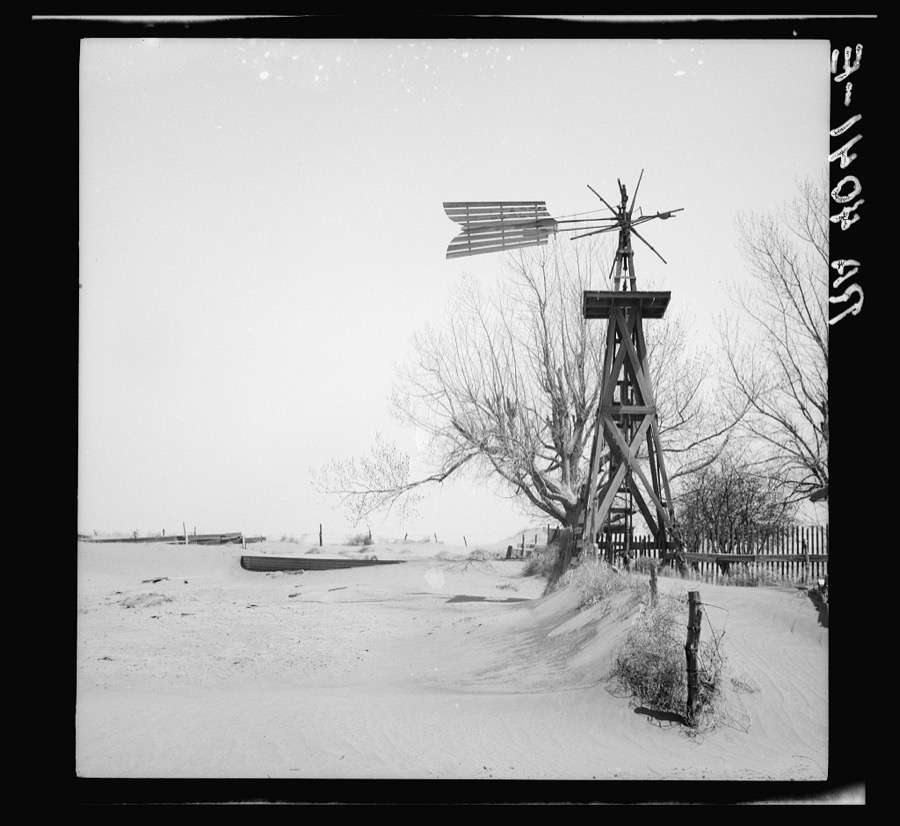 Windmill and tank on an abandoned farm. Cimarron County, Oklahoma