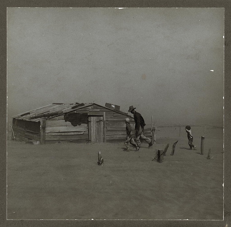 Farmer and sons walking in the face of a dust storm. Cimarron County, Oklahoma
