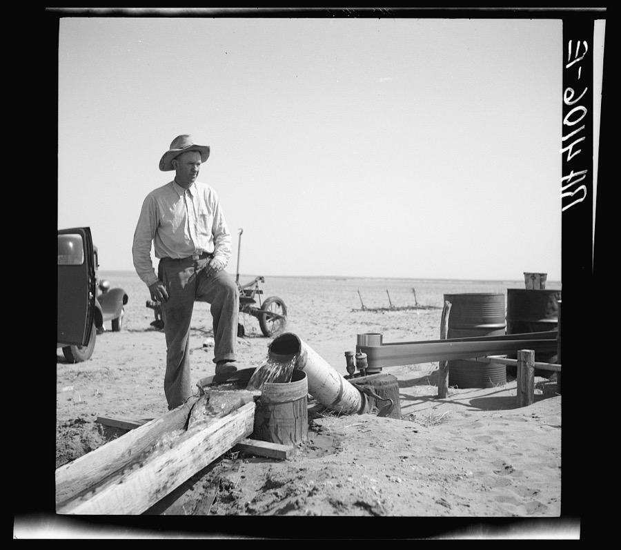 A possible solution to the dust problem is irrigation. This farmer is pumping water from a well to his parched fields. Cimarron County, Oklahoma