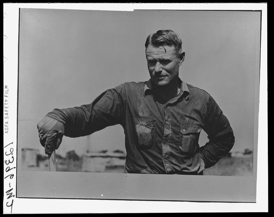 Roustabout in the ditch-digging crew. Notice the sweated shirt. Seminole oil field, Oklahoma