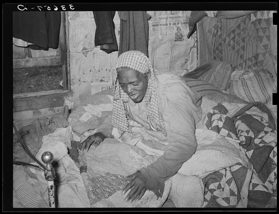 Old Negress, wife of agricultural day laborer, in bed with rheumatism. Wagoner County, Oklahoma
