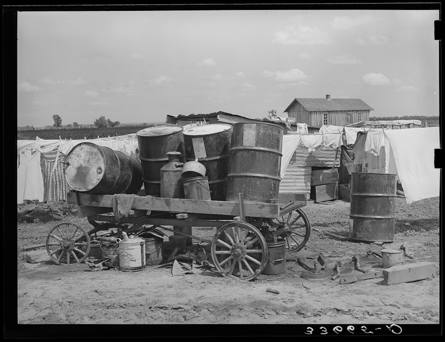 Scene on a tractor farm. Trailer loaded with oil drums. In Arkansas River bottoms near Vian, Oklahoma. Former tenant farmer is now day laborer