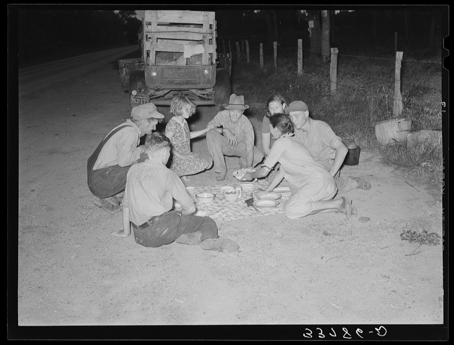 Migrant family encamped along roadside eating meal. Near Henryetta, Oklahoma
