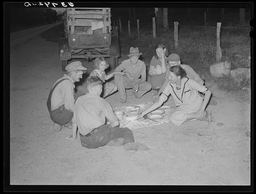 Migrant family encamped along roadside eating meal. Near Henryetta, Oklahoma