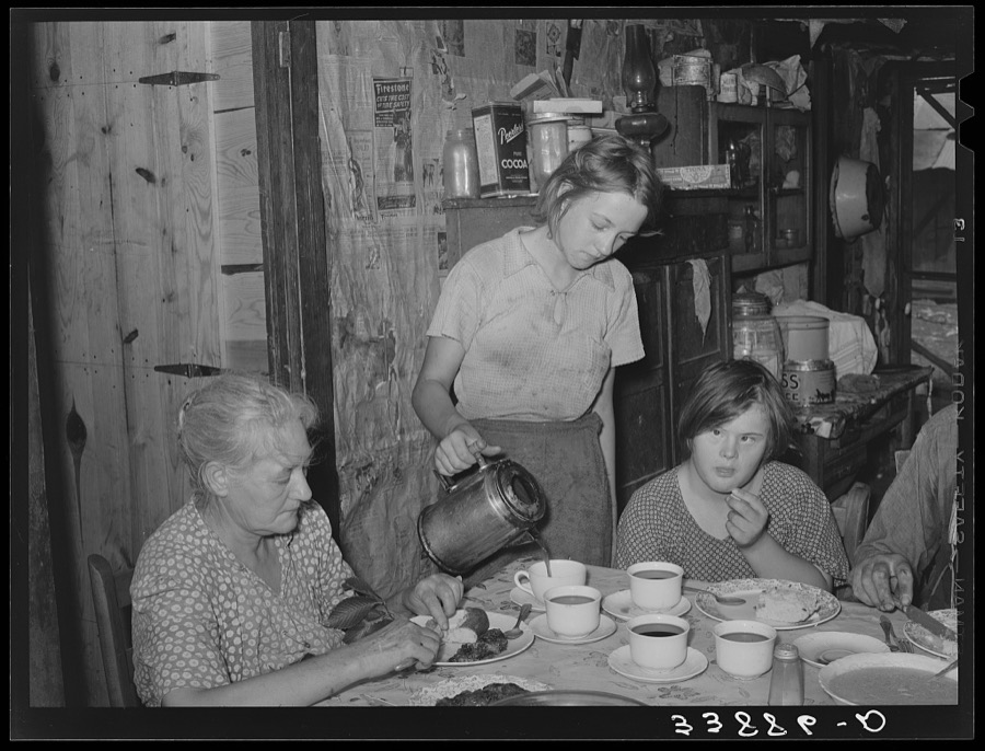 Daughter of tenant farmer pouring coffee at noonday meal. Near Muskogee, Oklahoma. See general caption number 20