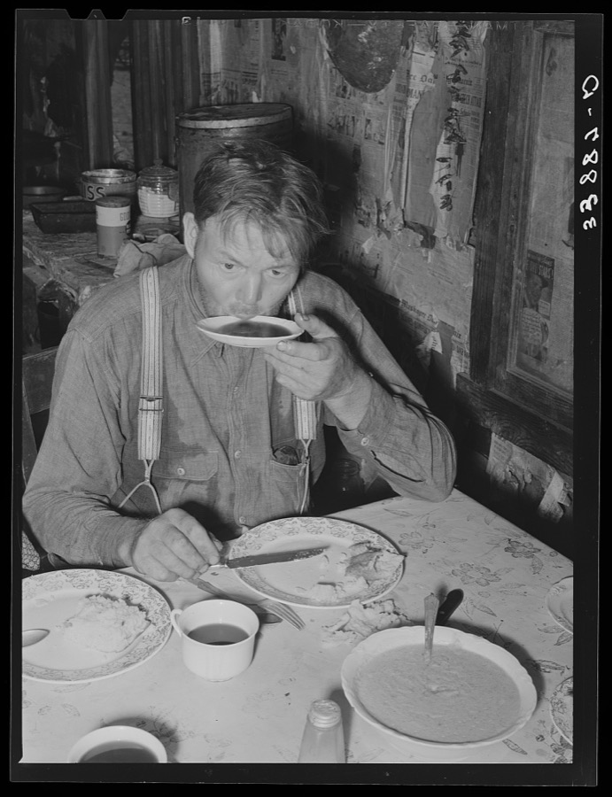 Tenant farmer drinking coffee at noonday meal. Near Muskogee, Oklahoma. See general caption number 20