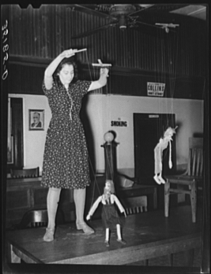 Member of the Red Dust Players, Oklahoma City theater group, operating puppets for the entertainment of meeting of UCAPAWA (United Cannery, Agricultural, Packing, and Allied Workers of America) members. Bristow, Oklahoma