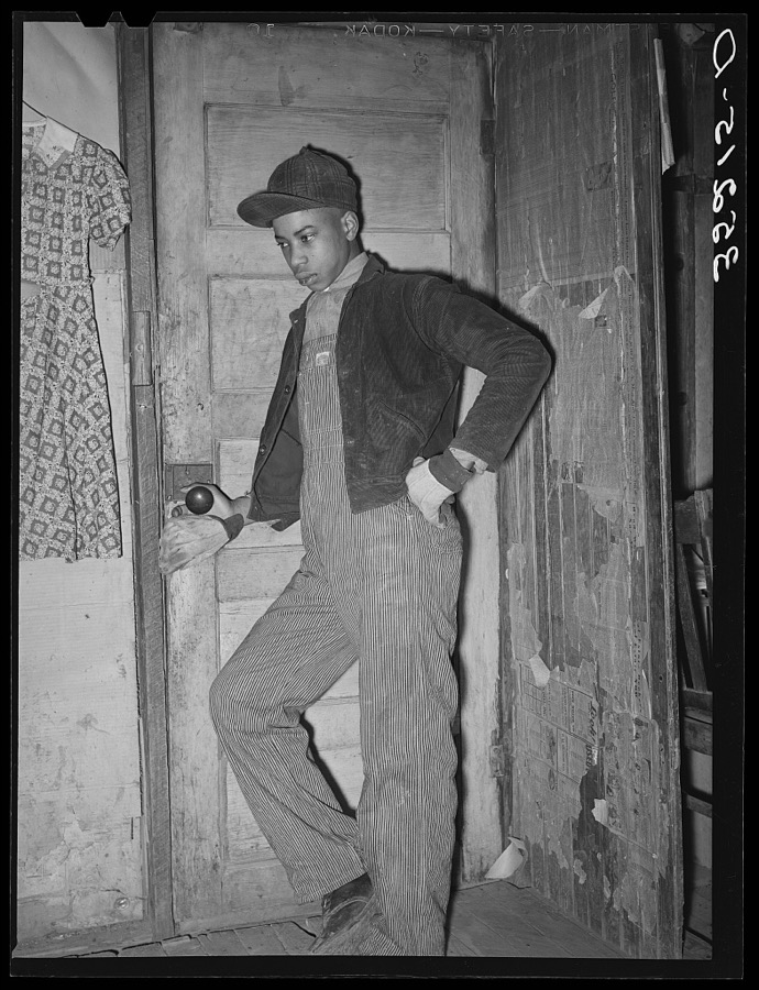 Son of Pomp Hall, Negro tenant farmer, coming through doorway in his house. Creek County, Oklahoma. See general caption number 23