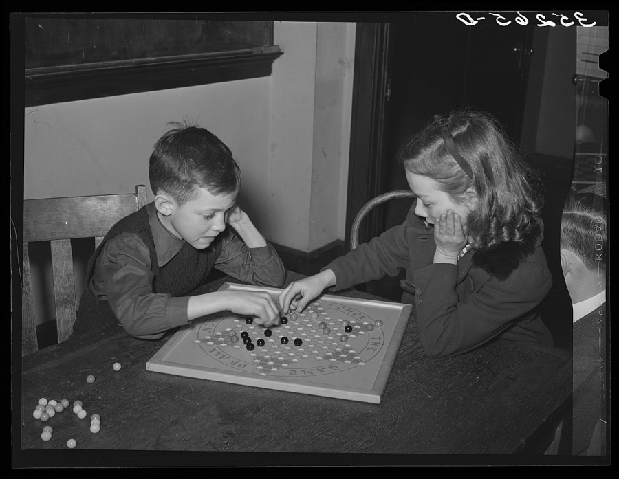 Boy and girl playing Chinese checkers. Eufaula, Oklahoma