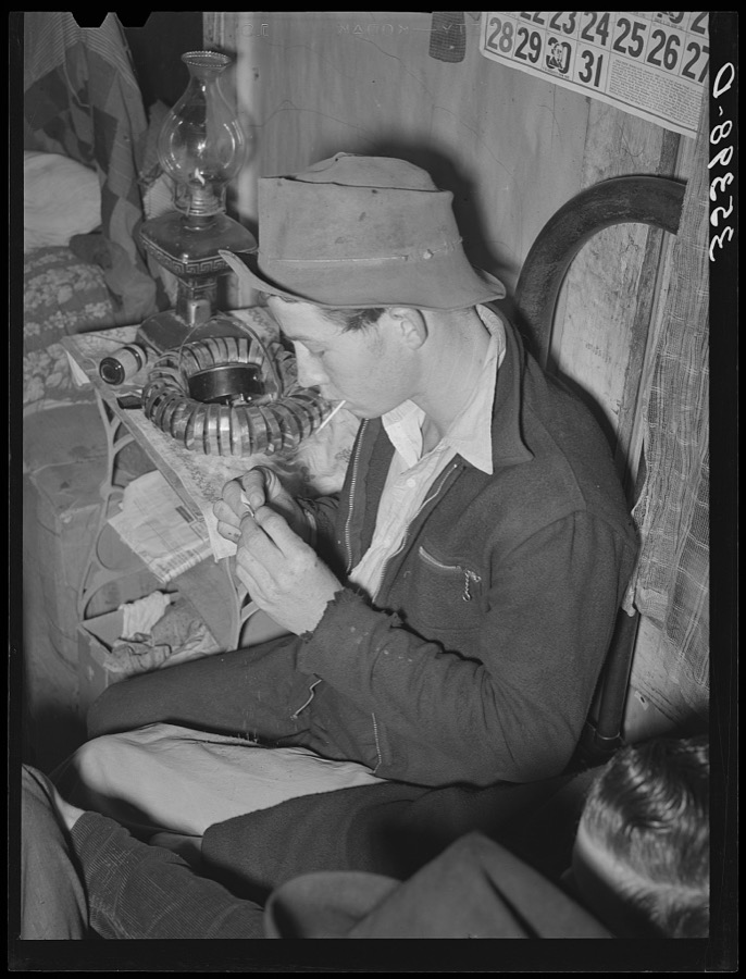 Farm boy rolling a cigarette. Play party in McIntosh County, Oklahoma. See general caption number 26