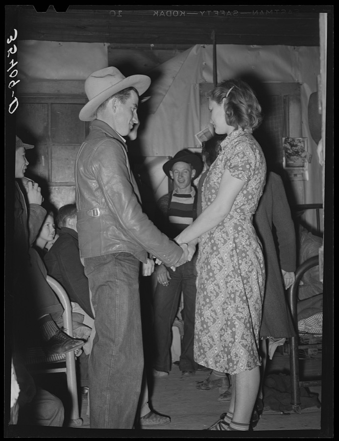 Farm boy and girl playing "Pleased or displeased" at play party in McIntosh County, Oklahoma. See general caption 26