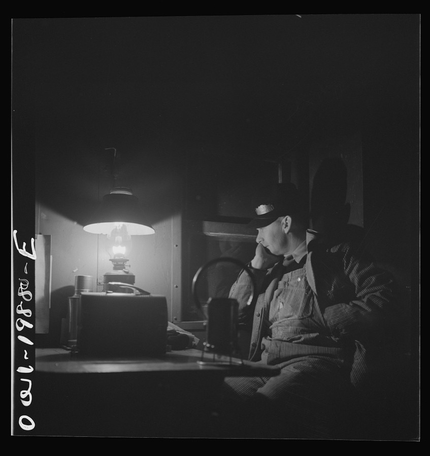 Waynoka, Oklahoma. Brakeman Jack Torbet, sitting at the window of the caboose pulling out of Waynoka, Oklahoma on the Atchison, Topeka, and Santa Fe Railroad