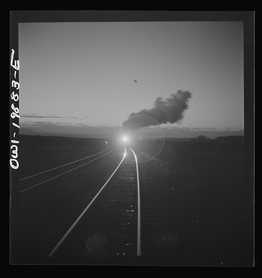 Belva, Oklahoma. Helper engine coming to help push the train on the Atchison, Topeka, and Santa Fe Railroad as far as Curtis, Oklahoma