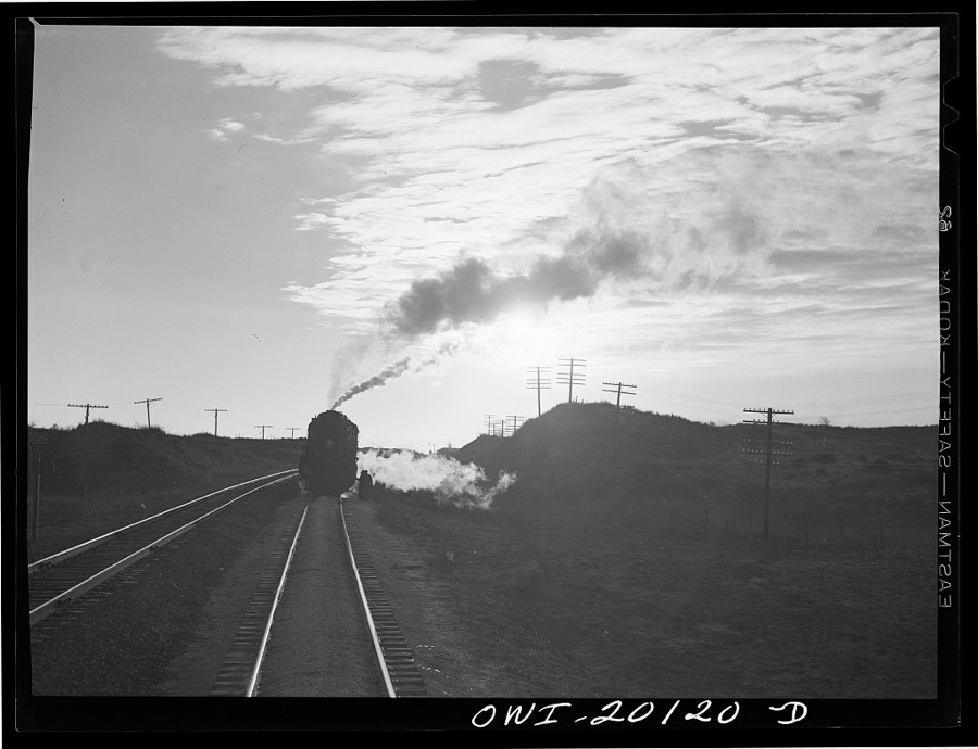 Curtis, Oklahoma. Helper engine leaving an Atchison, Topeka and Santa Fe train early in the morning after having helped push it from Belva, Oklahoma