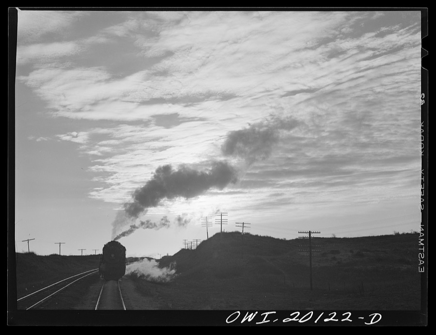 Curtis, Oklahoma. Helper engine leaving an Atchison, Topeka and Santa Fe train early in the morning after having helped push it from Belva, Oklahoma
