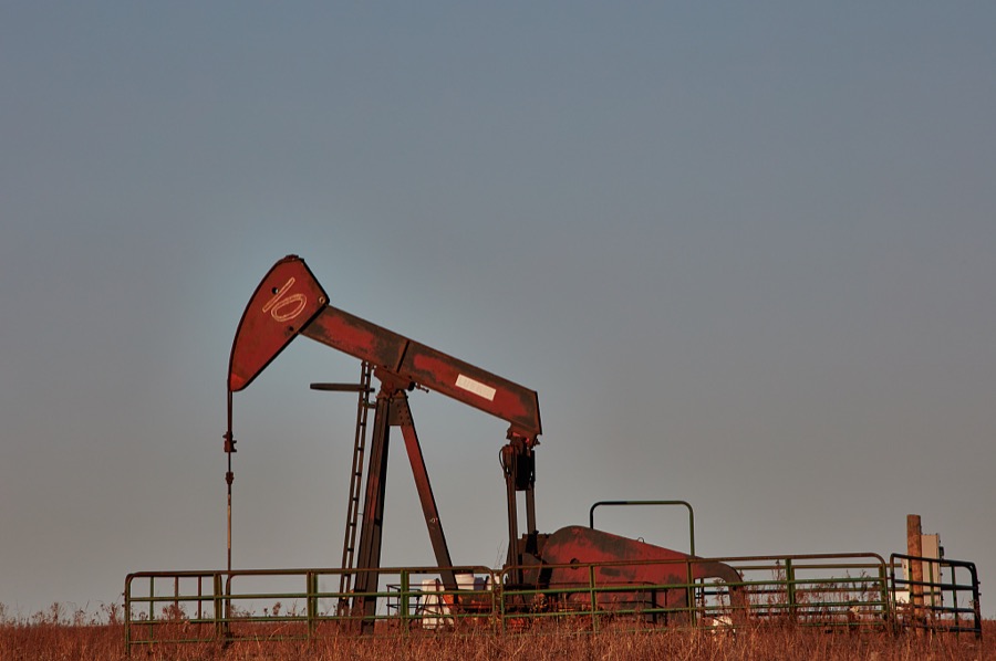 A pumpjack, or small extraction oil pump in the Joseph H. Williams Tallgrass Prairie Preserve, owned and managed by the Nature Conservancy near the town of Foraker, in Osage County, Oklahoma