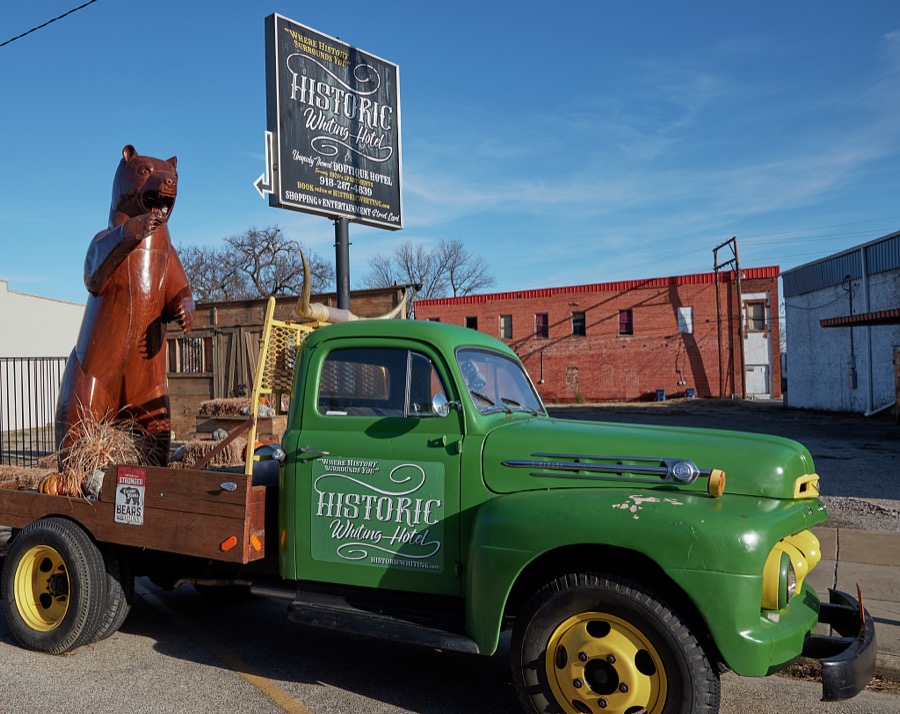 It's not entirely clear why a large bear figure in the back of a pickup truck is advertising the local, historic Whiting Hotel