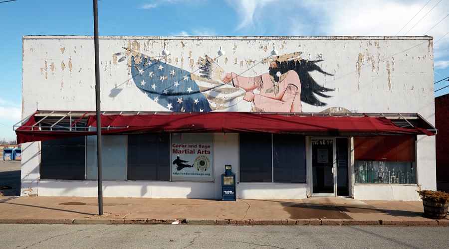 A chipped and fading mural of unspecified meaning in Anadarko, a small city in southwest Oklahoma that is home to the Apache Tribe