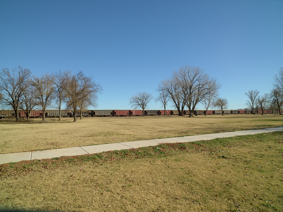A string of railroad boxcars lined up in downtown Chickasha (pronounced CHICK-a-shay), Oklahoma