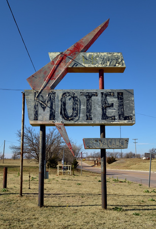 A very old, very deteriorated motel sign, with the motel itself nowhere to be found, in Canute, Oklahoma
