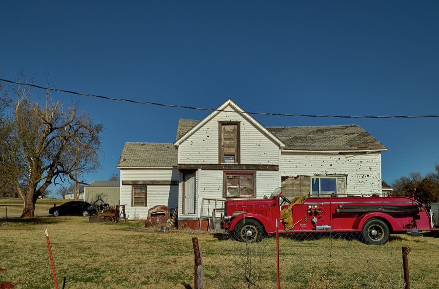 A fire truck is parked, inexplicably, outside this home in the tiny Oklahoma community of Foss, along old U.S. Highway 66