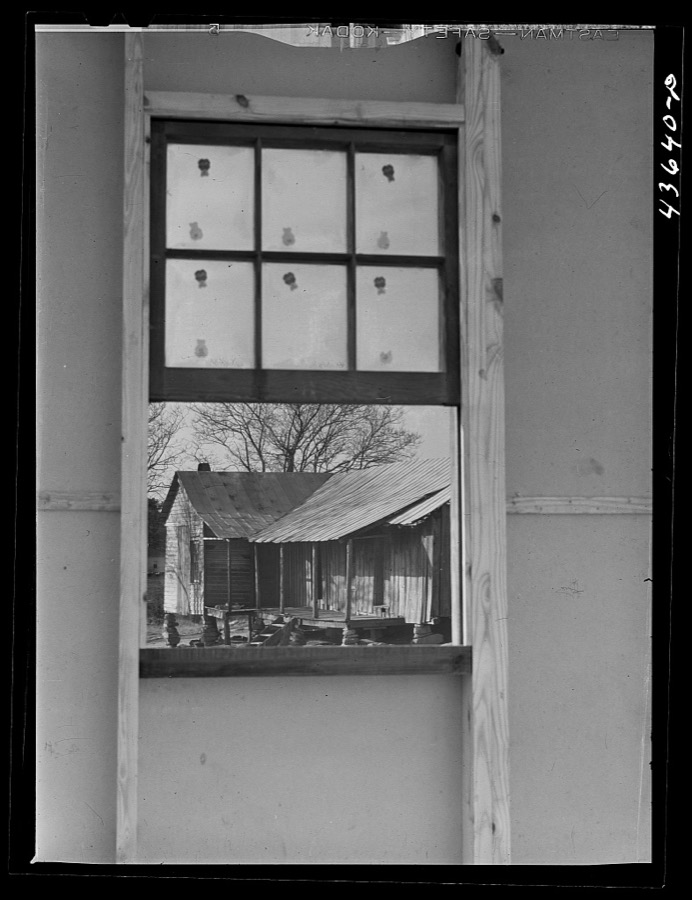 Old tenant house seen thru window of the prefabricated houses on the FSA (Farm Security Administraton) project in the Pacolet, South Carolina region