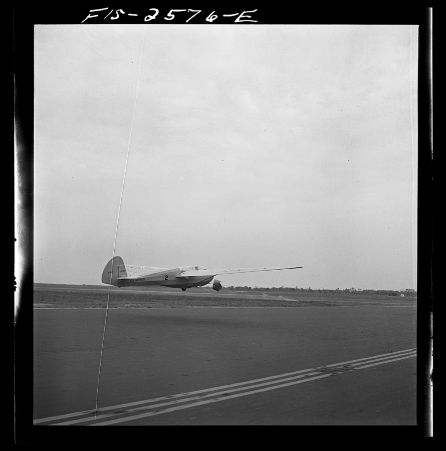 Parris Island, South Carolina. A glider plane being towed over a field at the U.S. Marine Corps glider detachment training camp