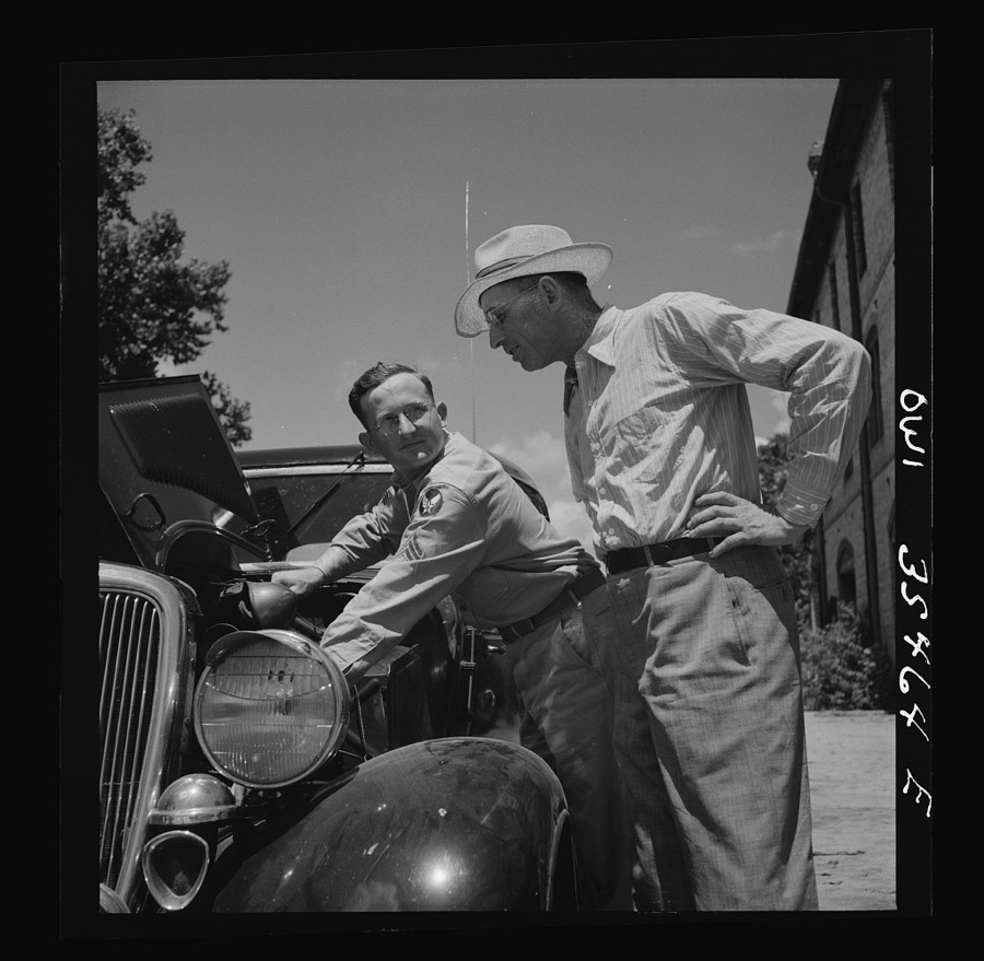Bowman, South Carolina. Sergeant John Riley of the 25th service group, Air Service Command, on leave at his home. He is tuning up his old Ford, preparing to go see his girlfriend