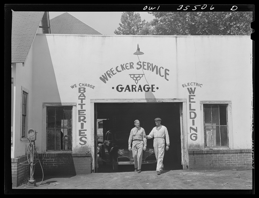 Bowman, South Carolina. Sergeant John Riley, of the 25th service group, Air Service Command, home on leave, being shown around the garage where he used to work by his father