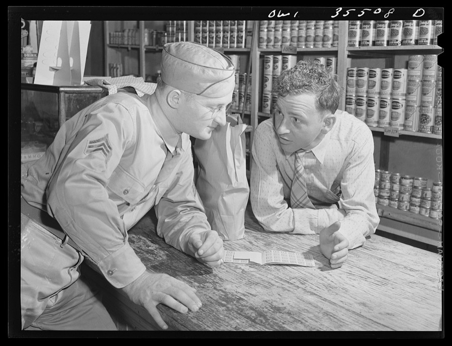 Bowman, South Carolina. Sergeant John Riley, of the 25th service group, Air Service Command, home on leave, learning about point rationing of food from his friend Windfred Judy, who runs the general store