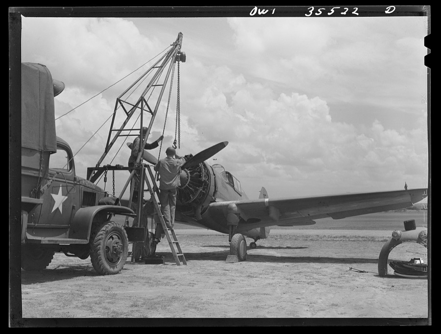 Greenville, South Carolina. Air Service Command. Men of the 35th service squadron of the 25th service group removing the propeller of a plane