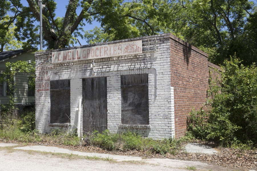 Old grocery store in a poorer neighborhood of Aiken, South Carolina. Note the curious message on the facade, pointing out that appliances were sold out the back door
