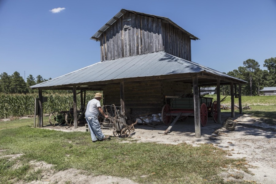 Historic re-enactor Dennis S. Ward depicts farm life at the L.W. Paul Living History Farm, a historical museum complex near Conway in Horry County, South Carolina