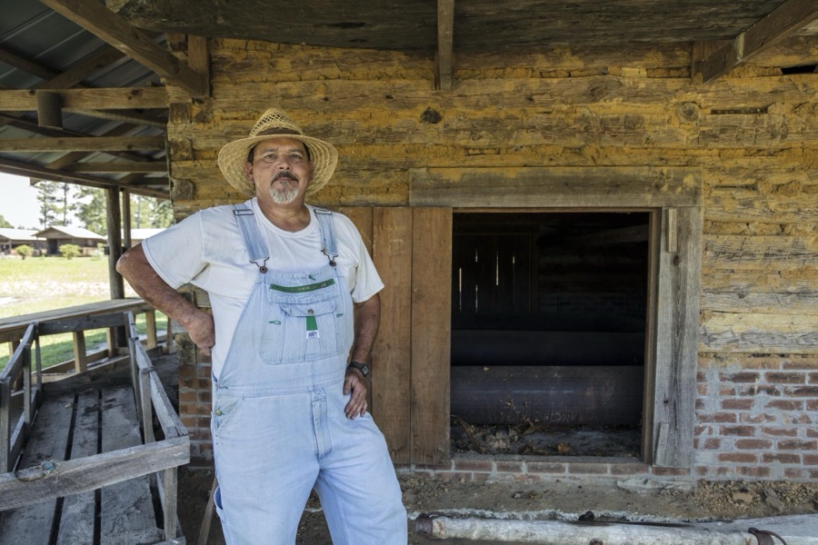 Historic re-enactor Dennis S. Ward depicts farm life at the L.W. Paul Living History Farm, a historical museum complex near Conway in Horry County, South Carolina