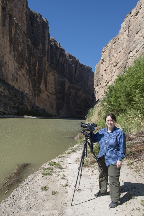 Photographer Carol M. Highsmith pauses between clicks of her Phase One 80-megapixel professional camera at the Santa Elena Canyon, deep in Big Bend National Park in Brewster County, Texas. A sheer rock wall in Mexico is to the left, one in the United States to the right
