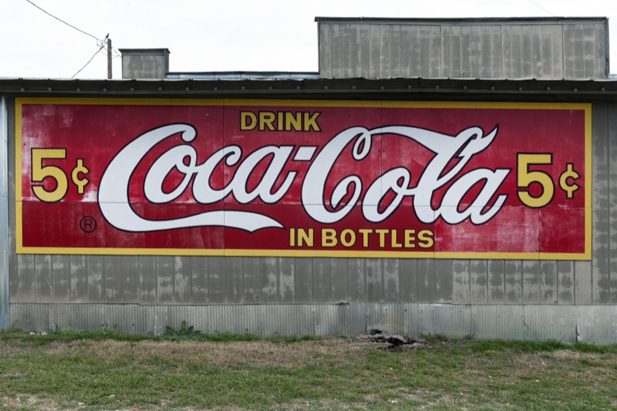 Old Coca-Cola sign on a building in Pipe Creek, a small community in Bandera County, Texas