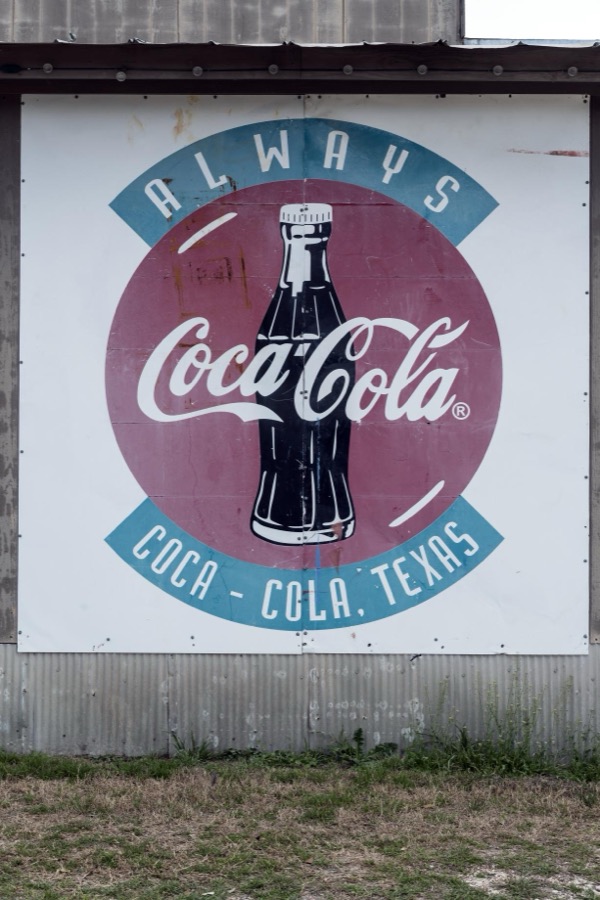 Old Coca-Cola sign on a building in Pipe Creek, a small community in Bandera County, Texas