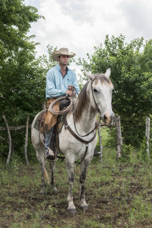 Cowhand Robert Vaughn, atop his horse, Dunnie, at the 1,800-acre Lonesome Pine Ranch, a working cattle ranch that is part of the Texas Ranch Life ranch resort near Chappell Hill in Austin County, Texas