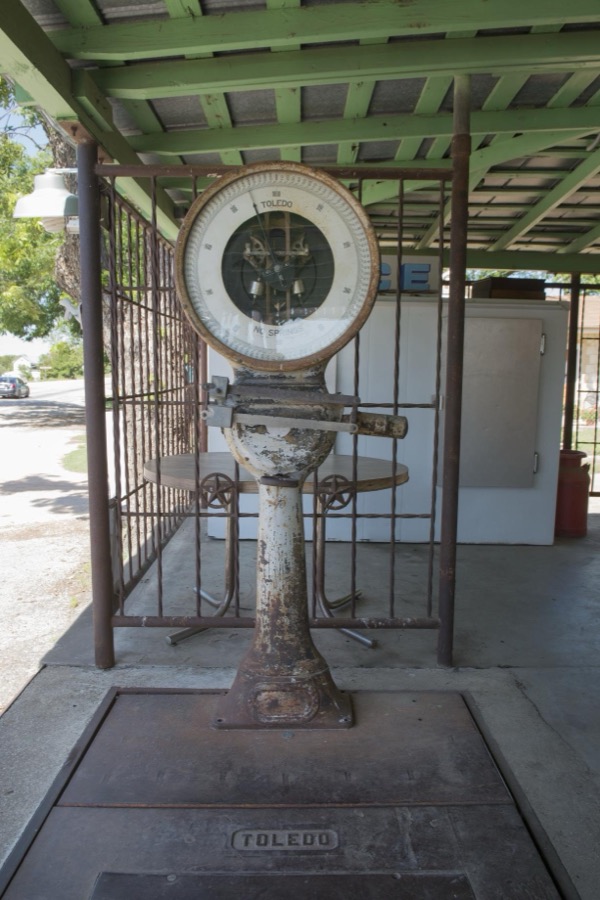 Old scale on the porch of the "Hye" store and post office in Blanco County, west of Johnson City, Texas