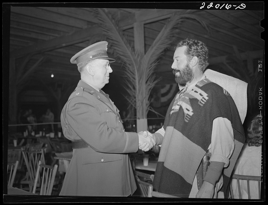 Brownsville, Texas. Charro Days fiesta. A bandido shakes hands with a local military officer