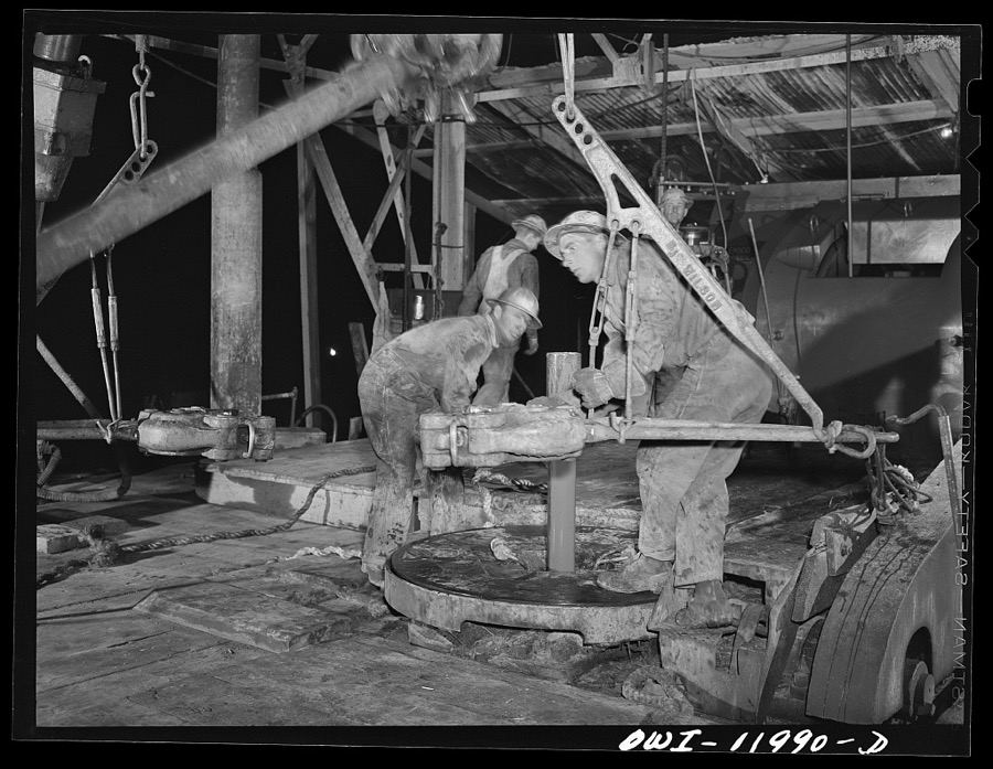 Andrews County, Texas. Preparing to add a new section of pipe on night tour