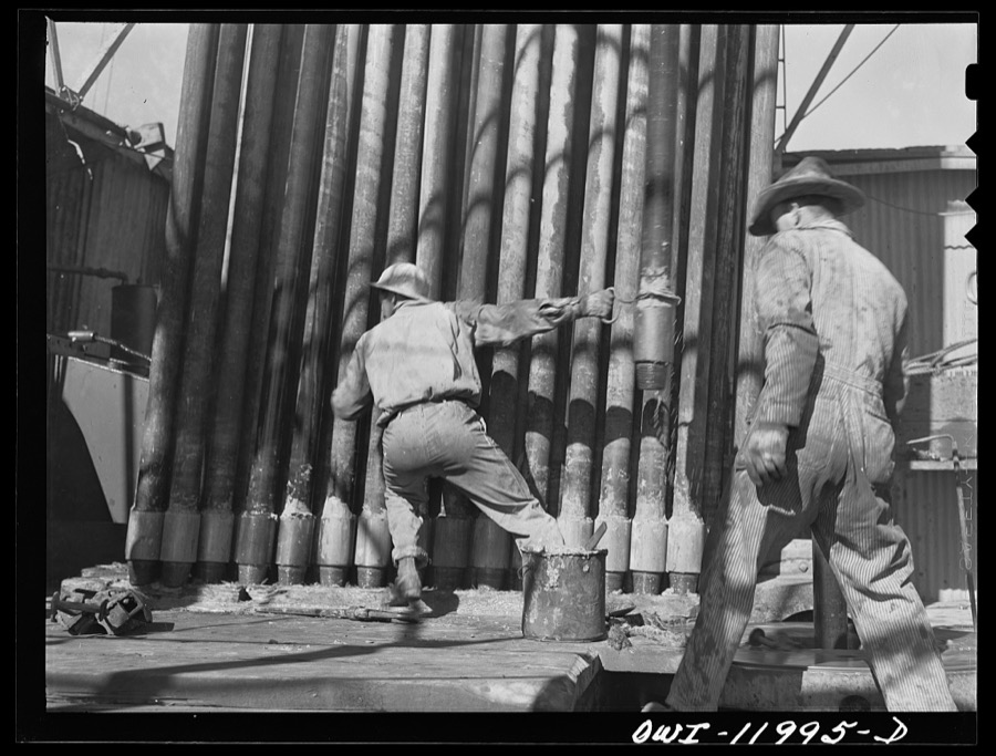 Andrews County, Texas. Putting section of pulled drill pipe into place