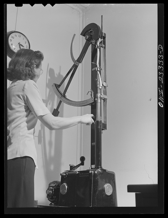 Lufkin, Texas. Southland paper mill. Laboratory worker testing tensile strength of a strip of newsprint
