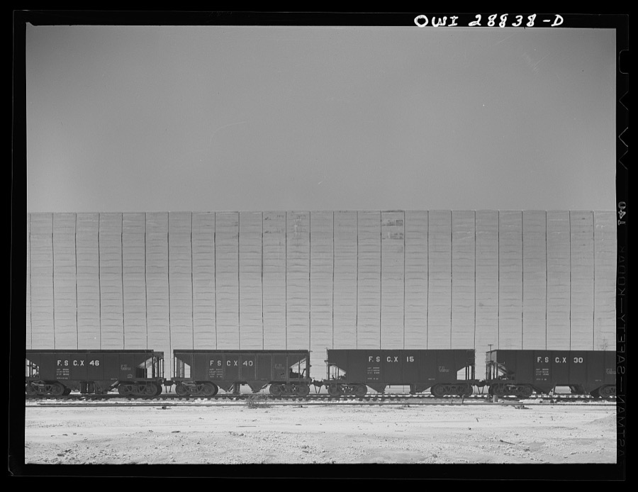 Freeport Sulphur Company, Hoskins Mound, Texas. Railroad cars in front of a sulphur vat
