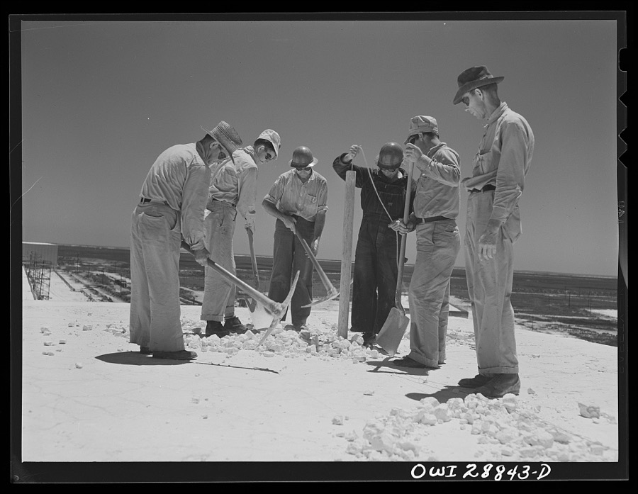 Freeport Sulphur Company, Hoskins Mound, Texas. Lowering dynamite into hole preparatory to blasting from top of vat