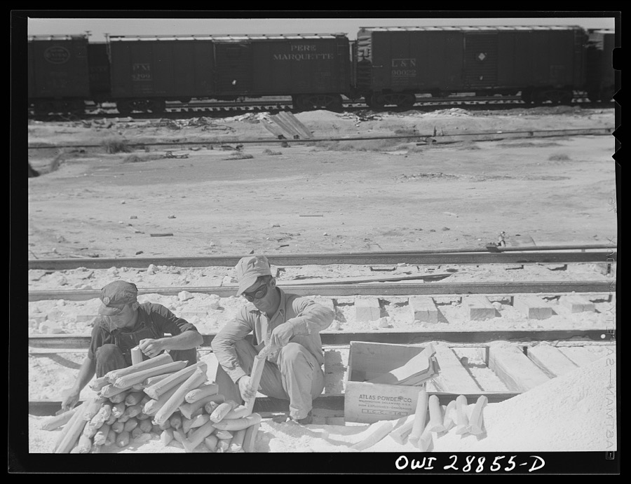 Freeport Sulphur Company, Hoskins Mound, Texas. Loading dynamite charges preparatory to blasting