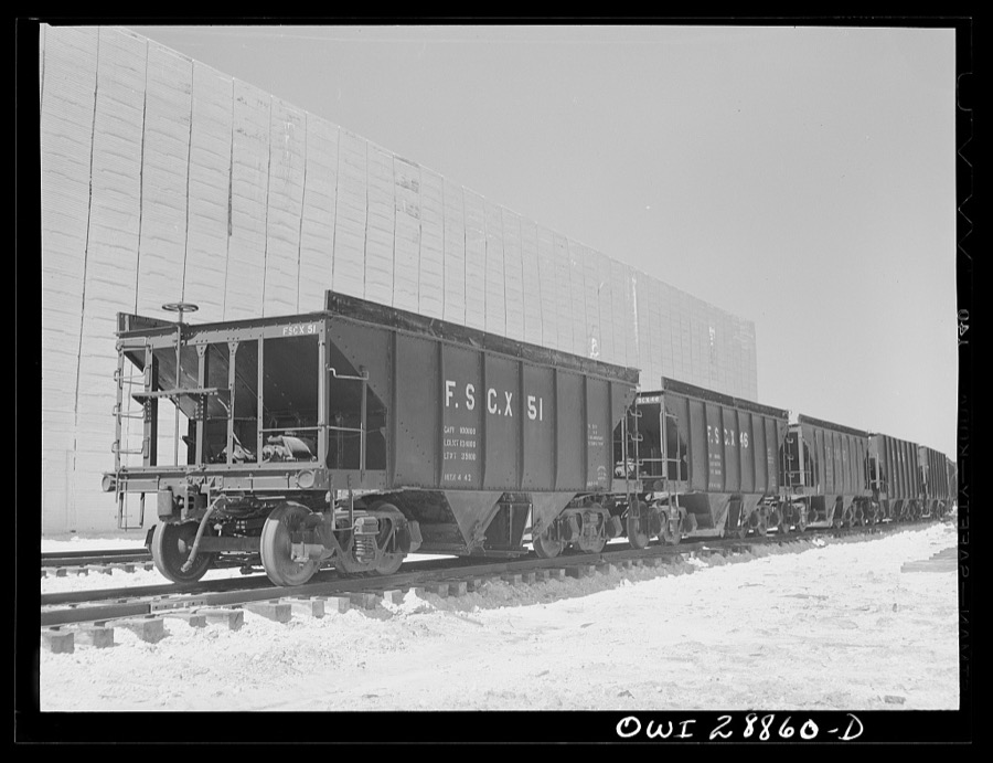 Freeport Sulphur Company, Hoskins Mound, Texas. Railroad cars in front of a sulphur vat